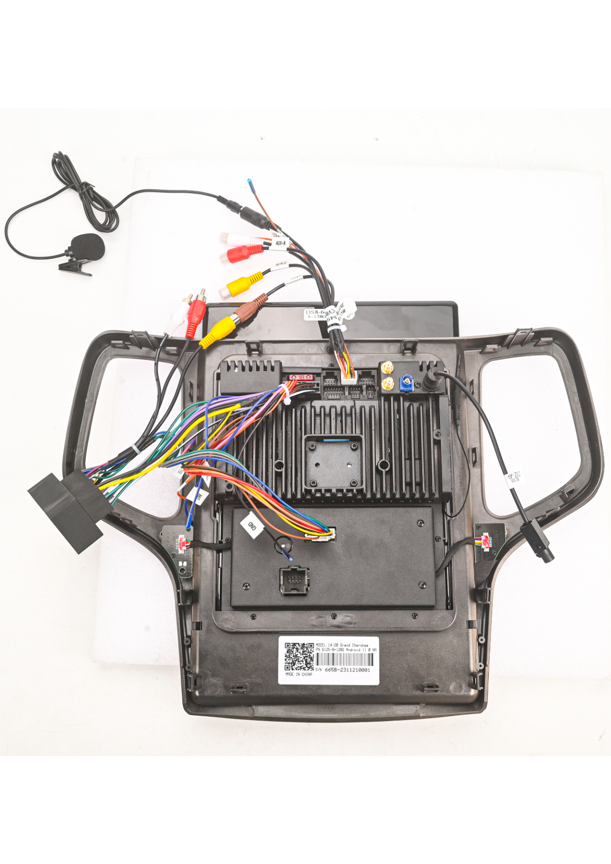 Jeep Grand Cherokee - Photo of the aftermarket head unit showing wiring connections and components.